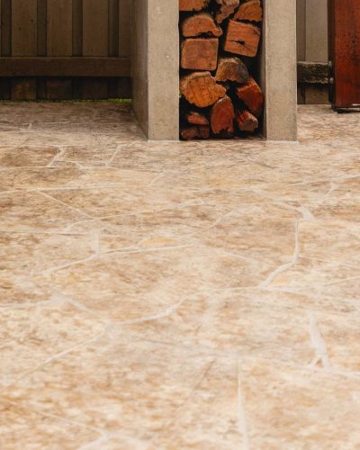 Stone-look crazy-pave pattern floor beside a firewood storage nook